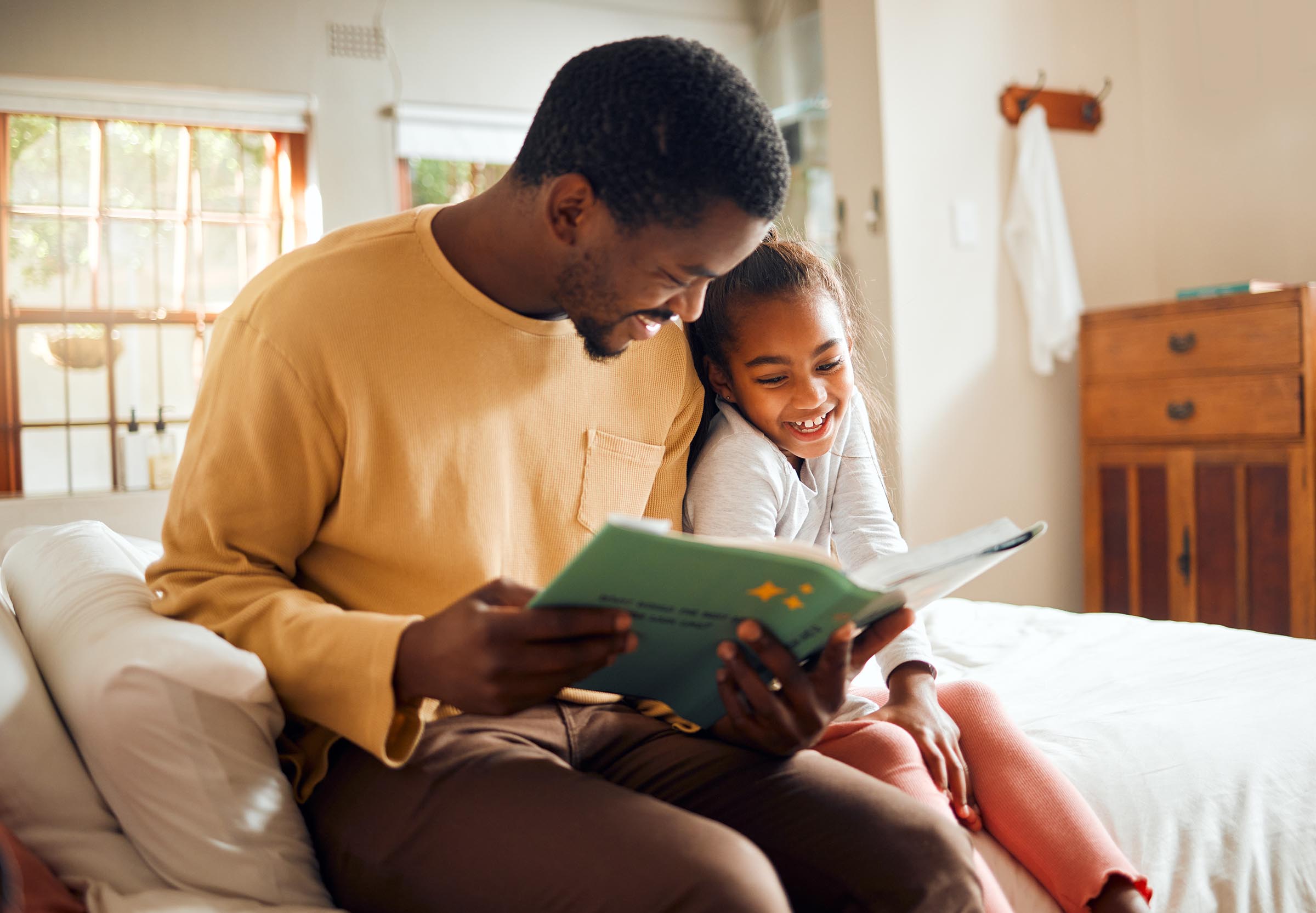 Father storytelling, child reading 