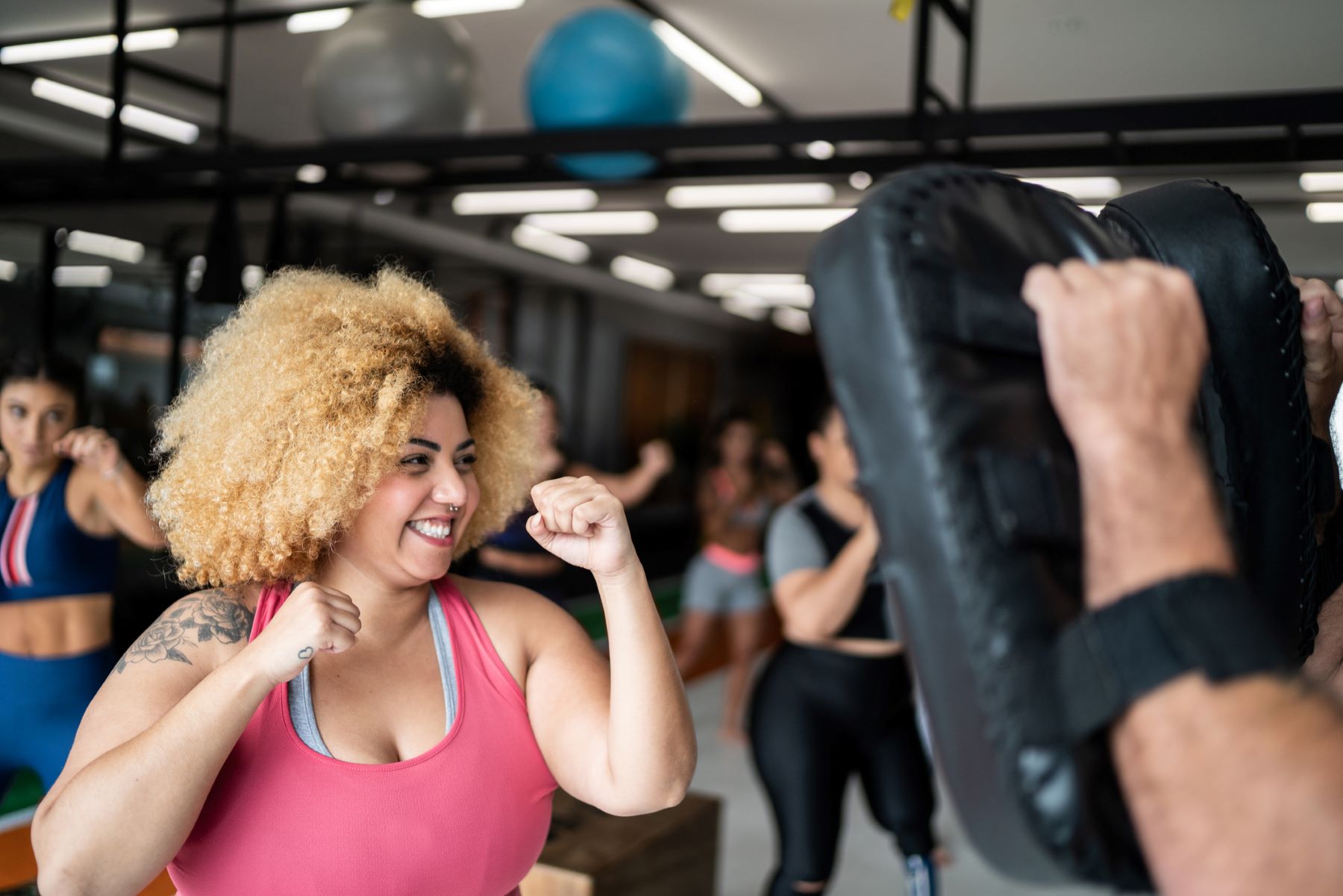 young woman hitting a punching bag