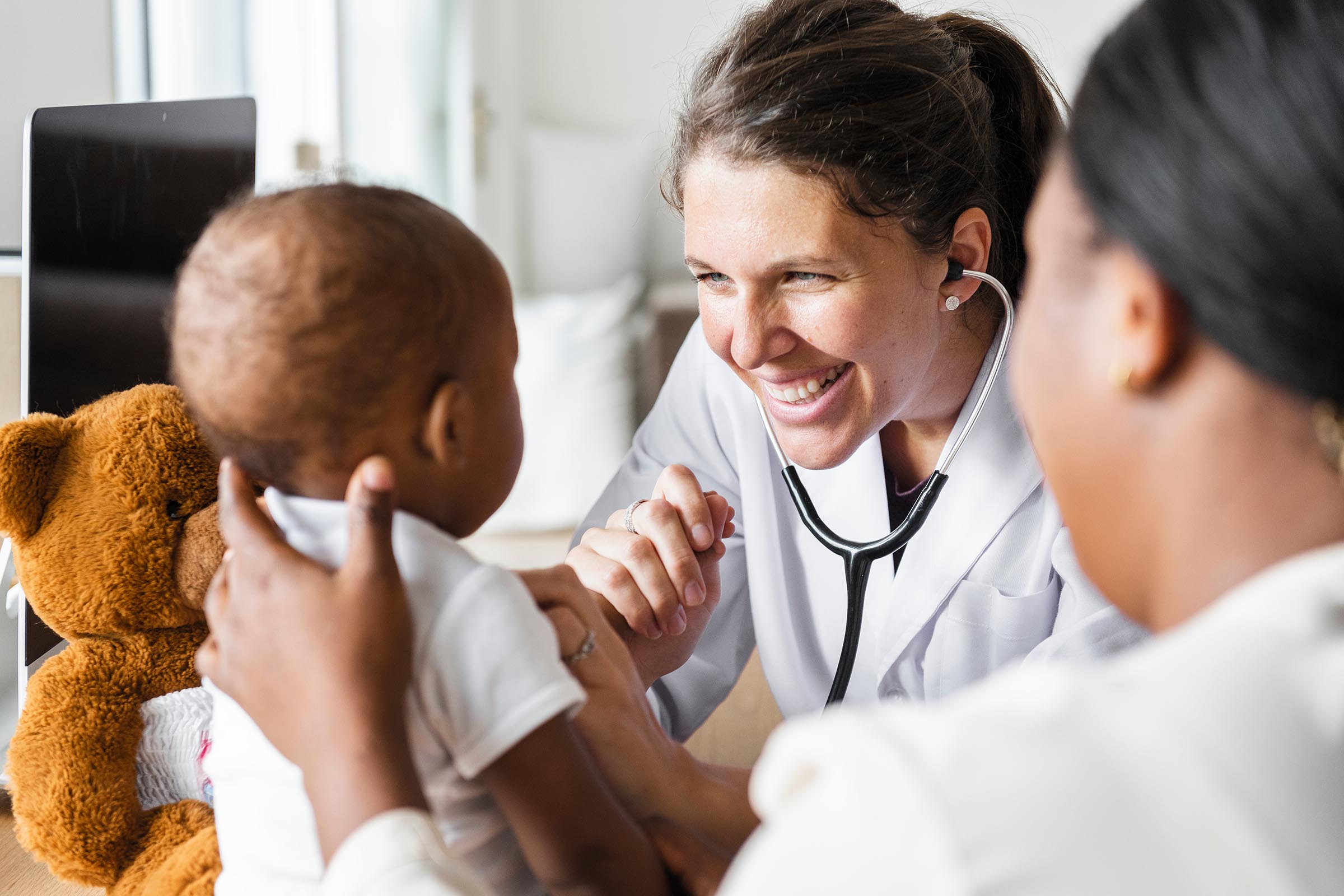 Mother and infant with woman doctor