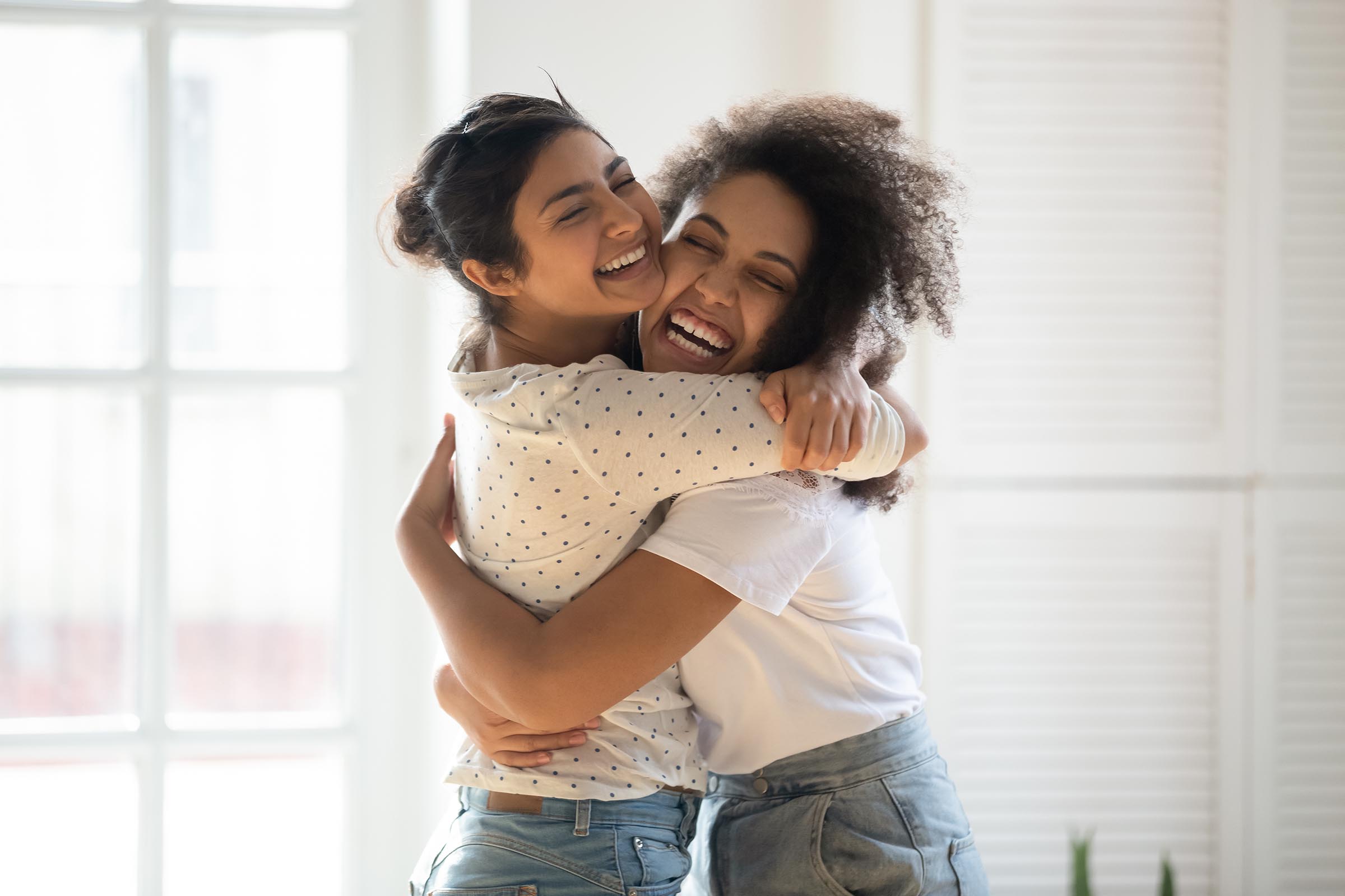 two happy girls hugging