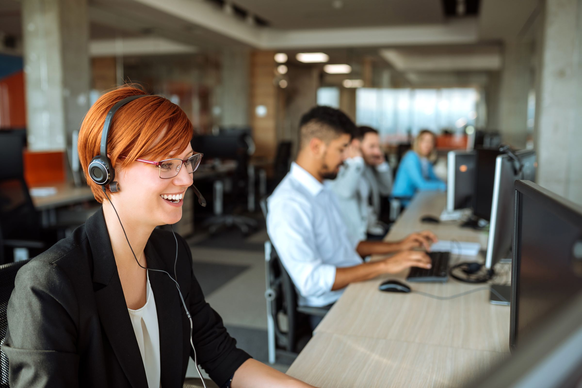 smiling call technician with headset talking on the phone