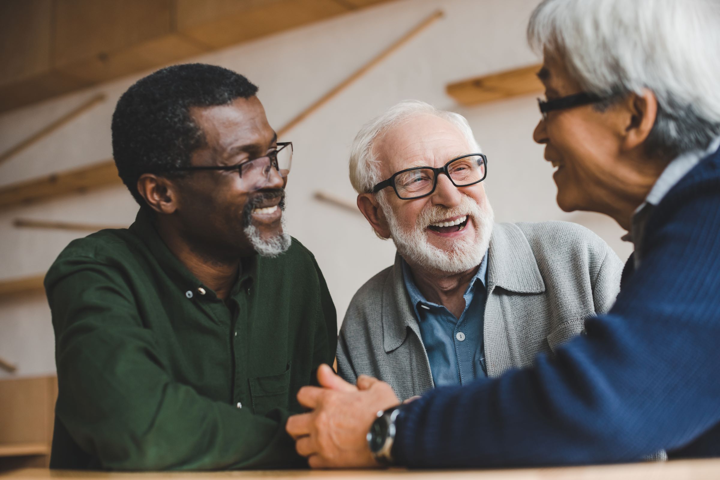 three men smiling and talking together