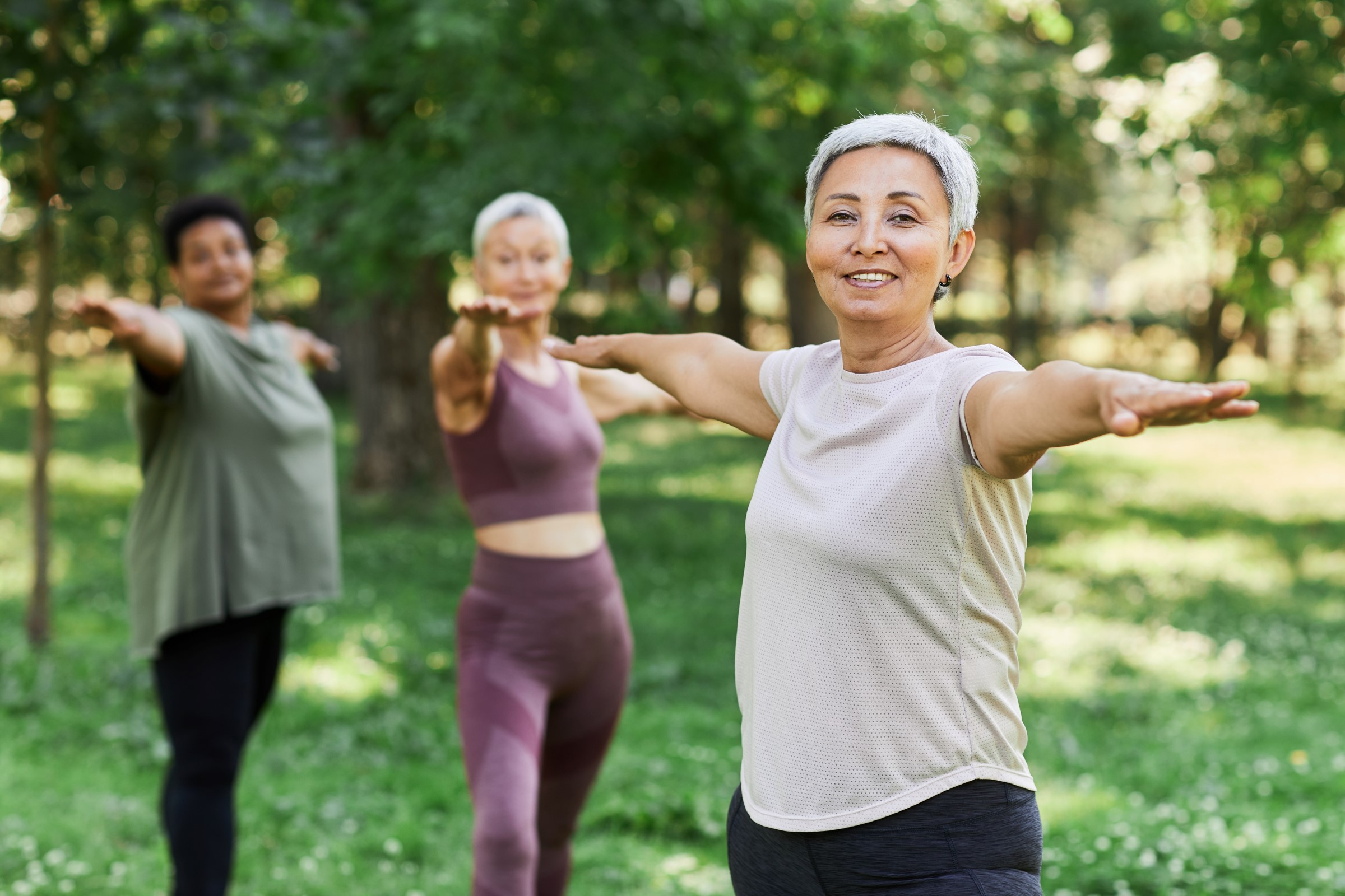 Three women exercising in the park